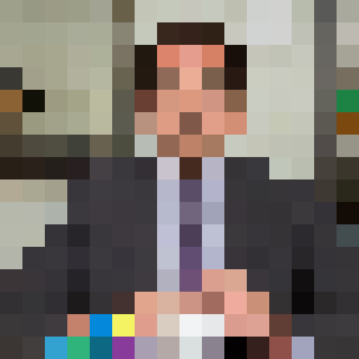 Middle-aged Caucasian male with receding dark hair, dressed in a business suit. Expressive eyebrows and a slightly bemused expression