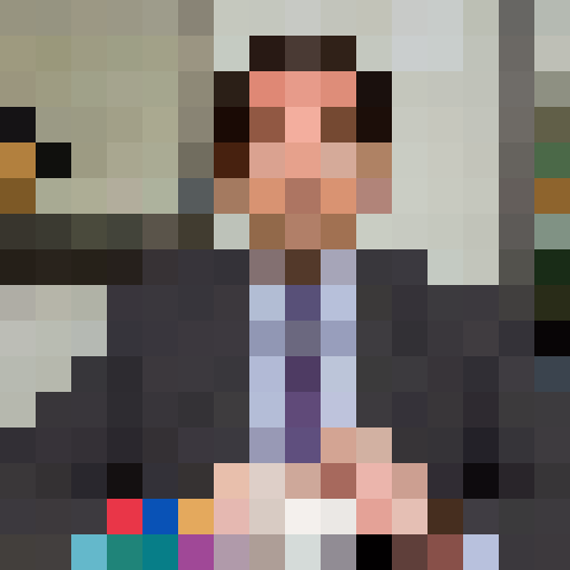 Middle-aged Caucasian male with receding dark hair, dressed in a business suit. Expressive eyebrows and a slightly bemused expression